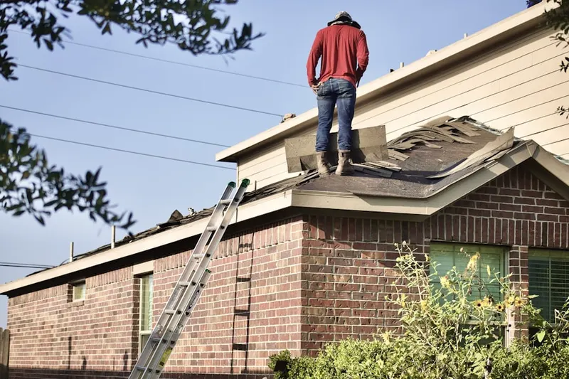 Professional roofer working on a residential roof in Schneider Crossroads